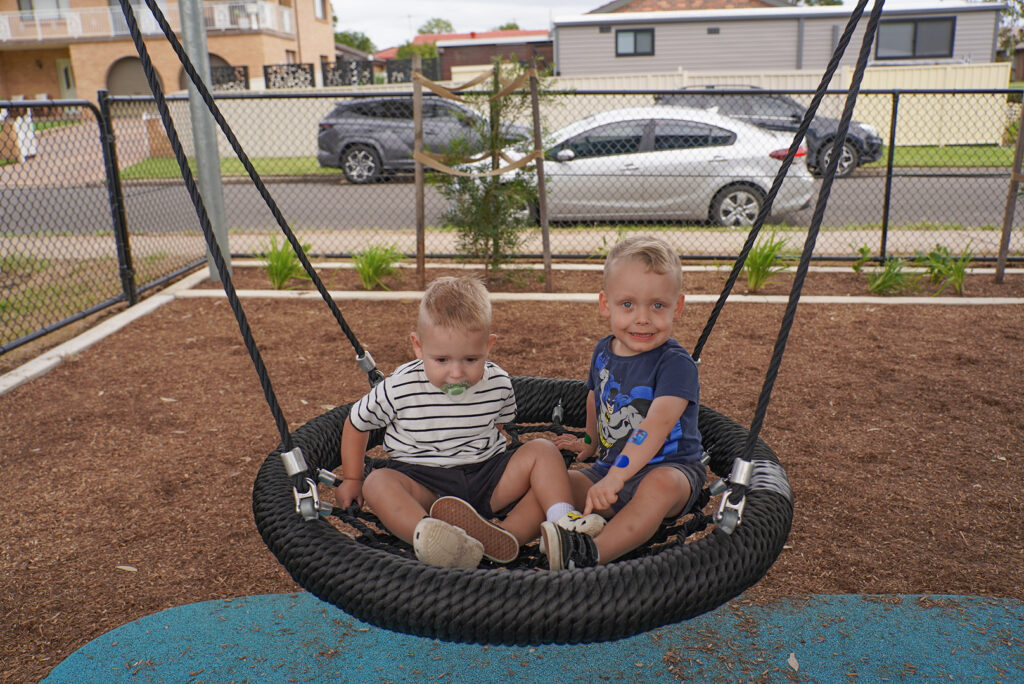 Kids play on the new basket swing at Jim Anderson Park